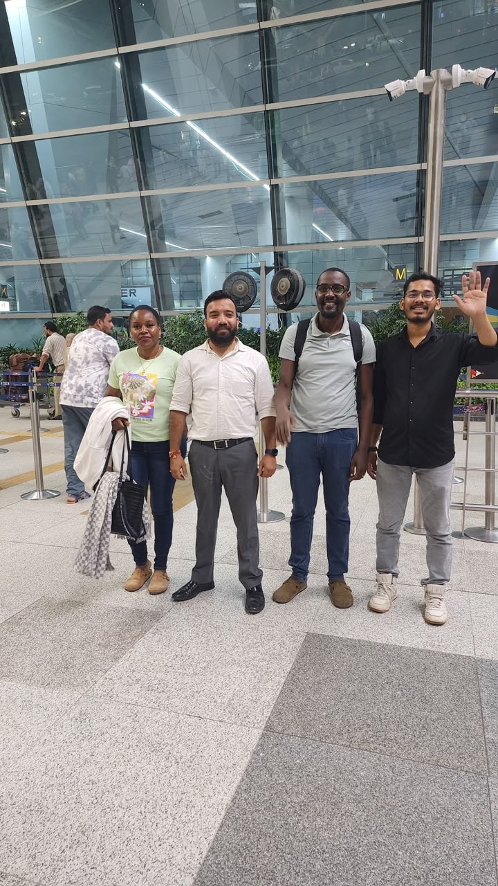 Patient from Tanzania with wife and Wiseheal Healthcare team at Delhi airport — acid reflux treatment success at Manipal Hospital