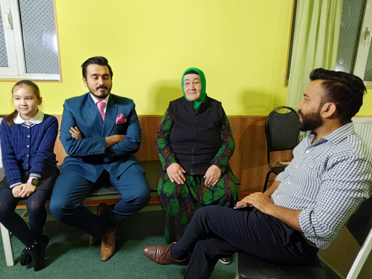 Wiseheal Healthcare team consulting a patient family at OPD camp in Uzbekistan — yellow room